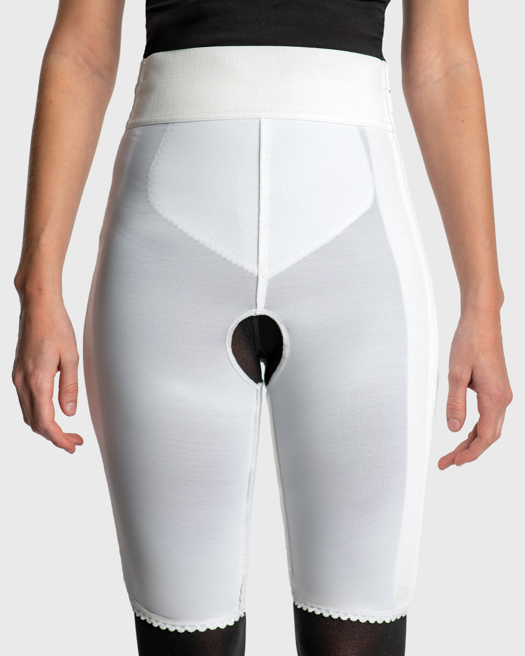 Front view of white above knee compression girdle with contact closure and front zipper for post-surgical recovery