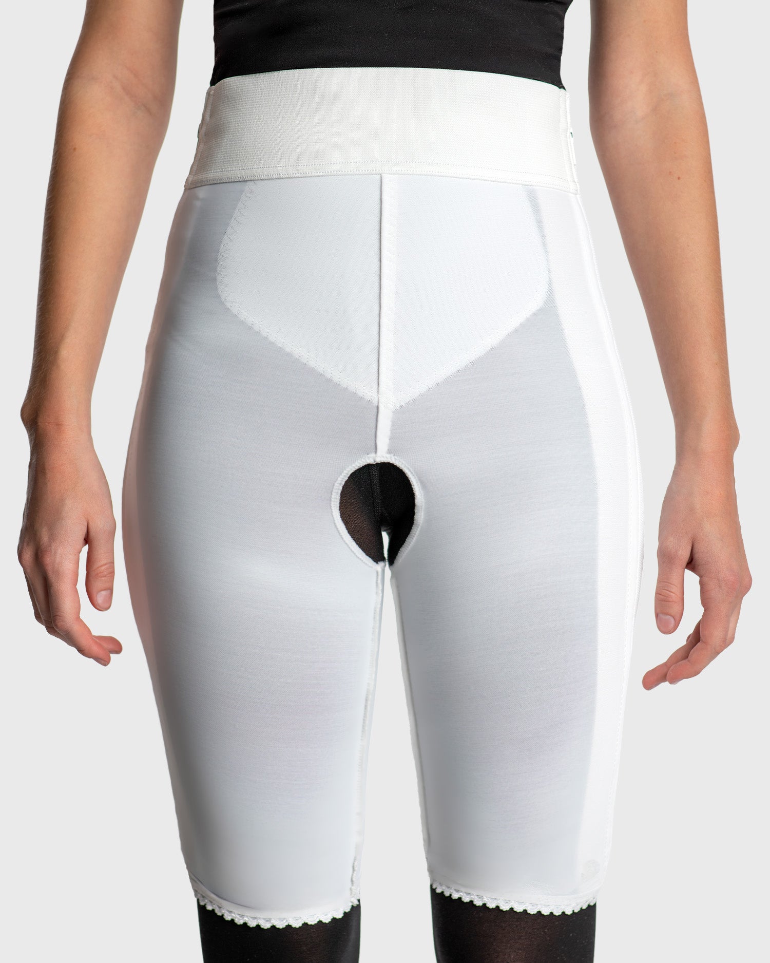 Front view of white above knee compression girdle with contact closure and front zipper for post-surgical recovery