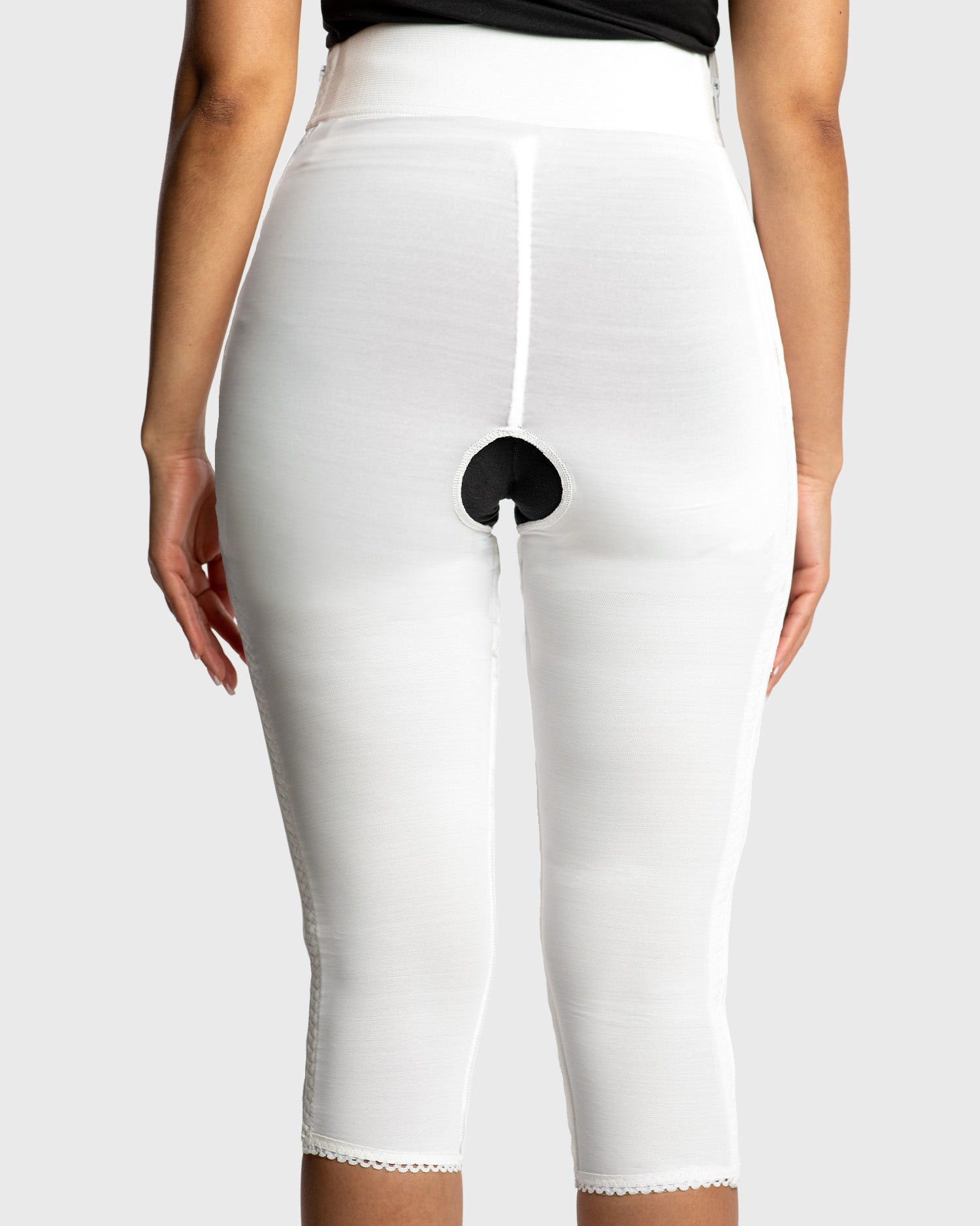 Rear view of white below knee compression girdle with contact closure for post op support