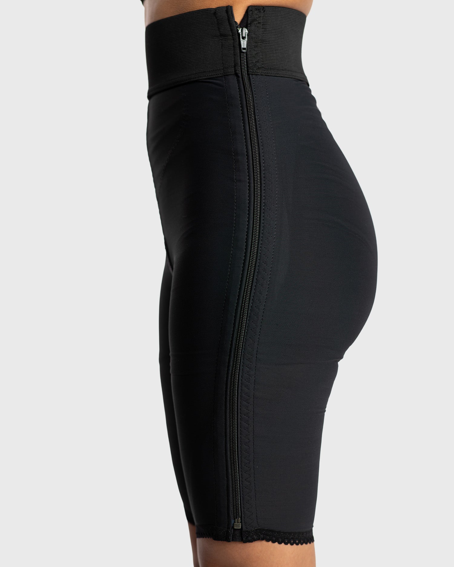 Side view of black above knee compression girdle with contact closure for post op shapewear