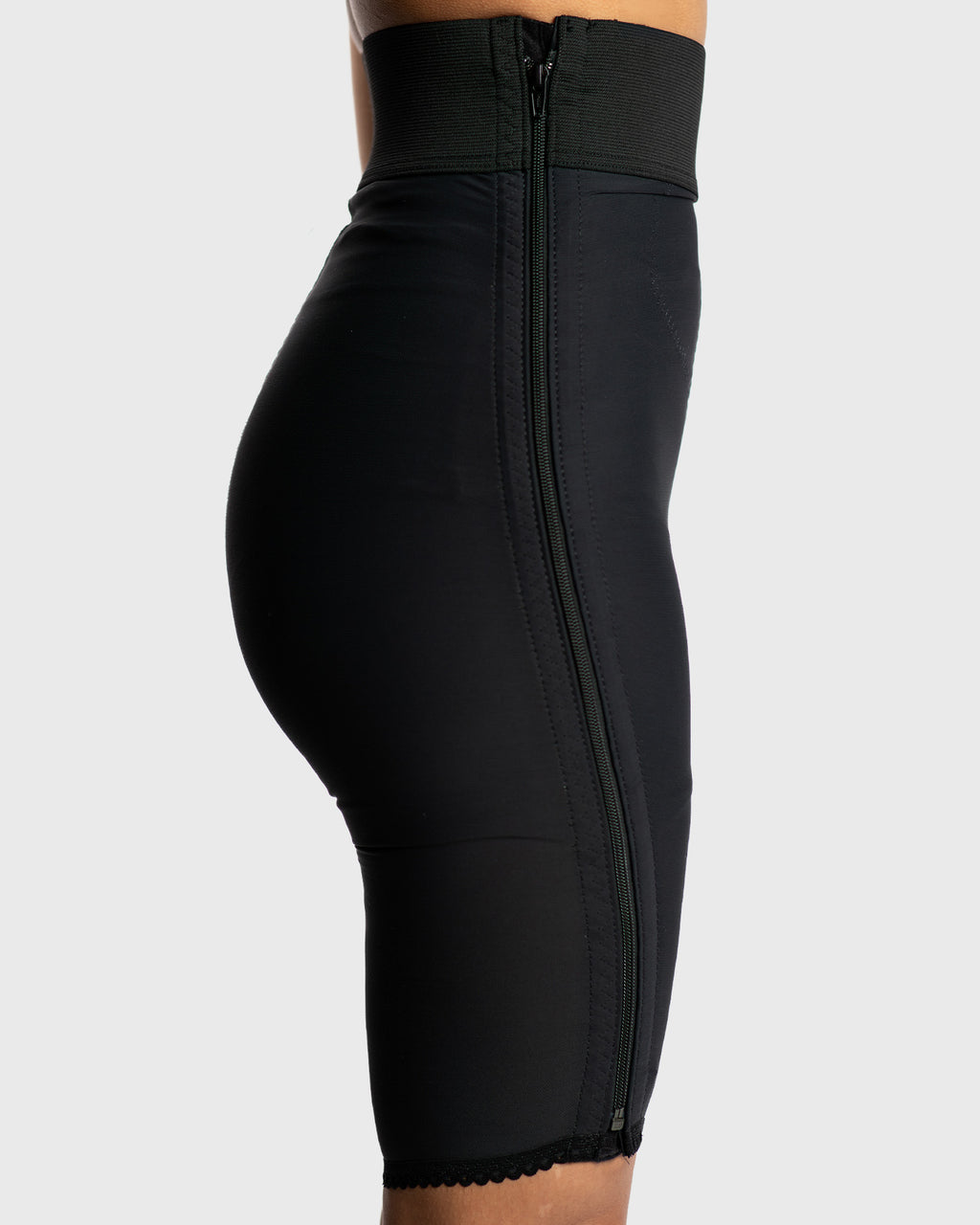 Side view of black above knee compression girdle with hook and eye closure for post op body contouring