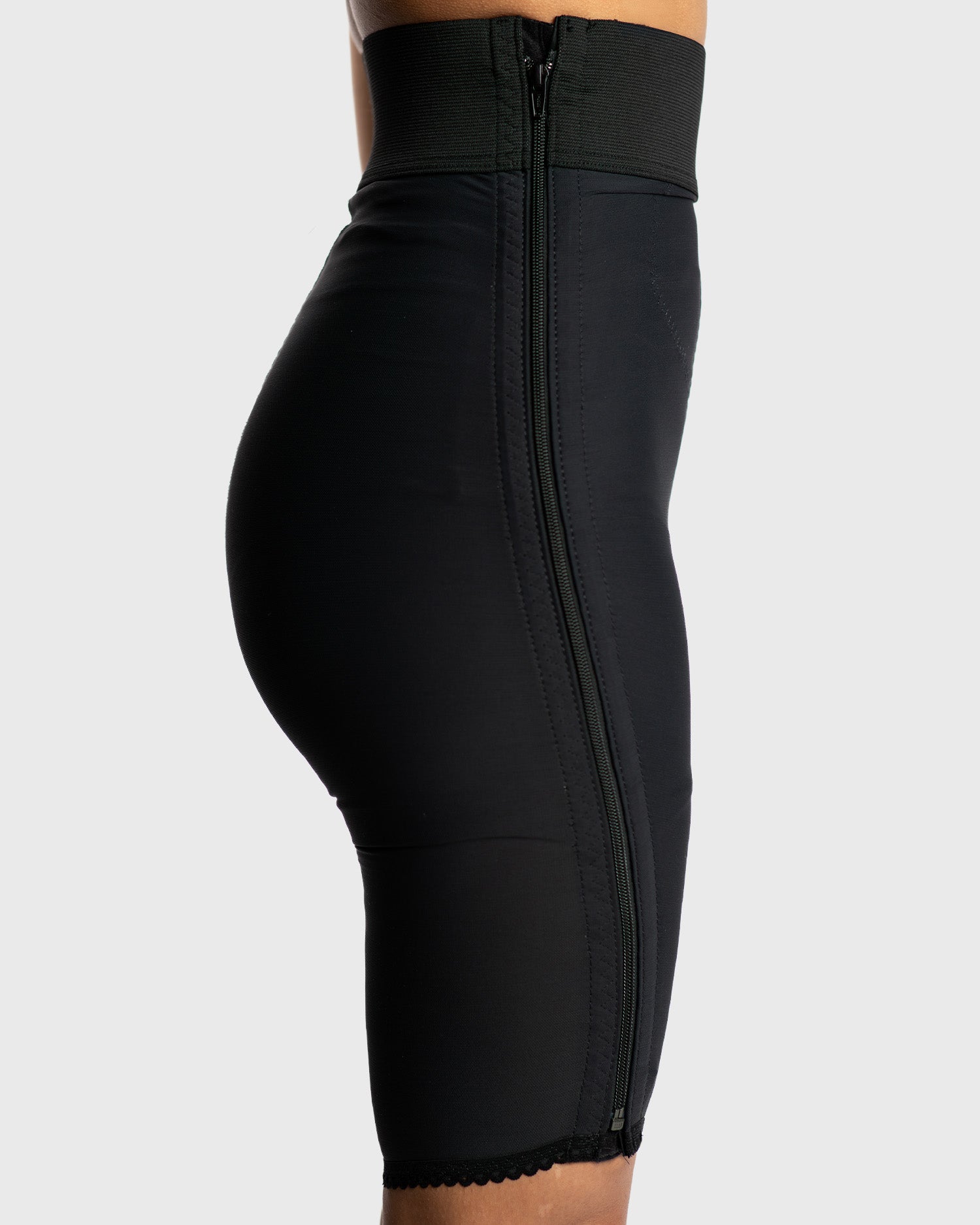 Side view of black above knee compression girdle with hook and eye closure for post op body contouring