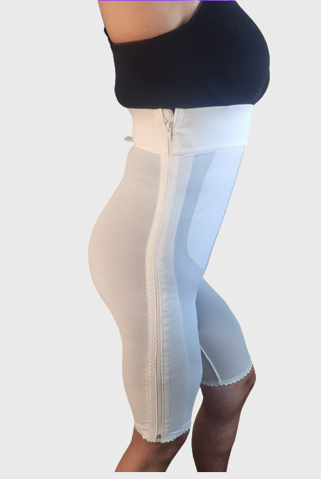 Side view of white high waist above knee compression girdle with hook and eye closure and front zipper for post-surgical recovery
