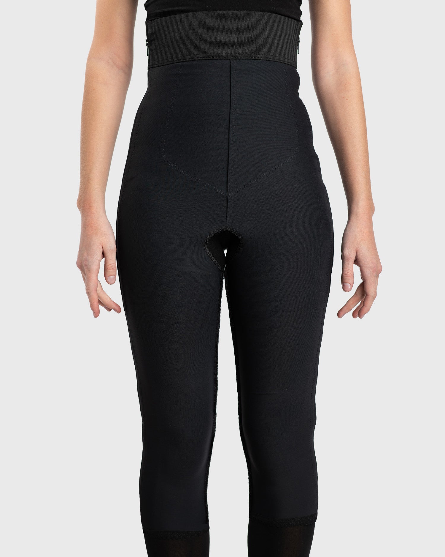 Front view of black high waist below knee compression girdle with hook and eye closure and front zipper for post-surgical recovery