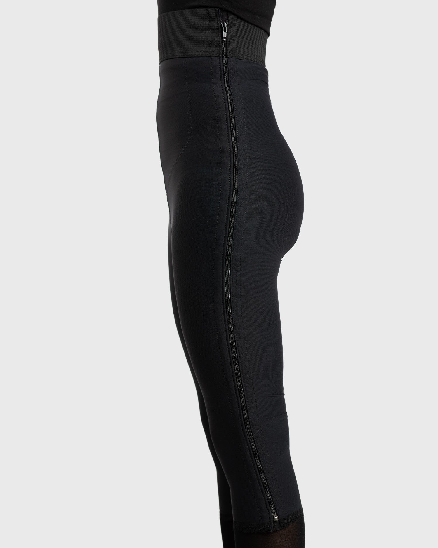 Side view of black high waist below knee compression girdle with hook and eye closure for post op support
