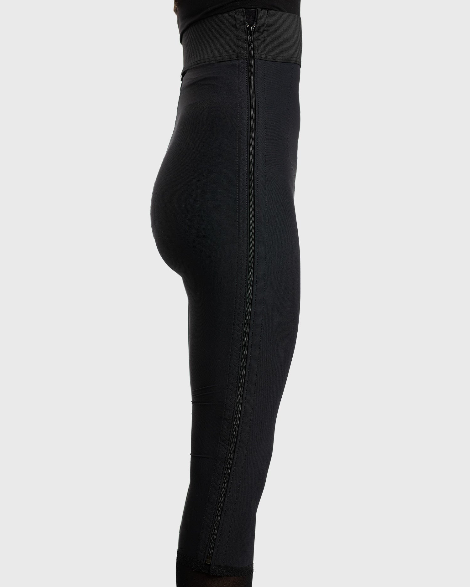 Side view of black high waist below knee compression girdle with hook and eye closure for post op support