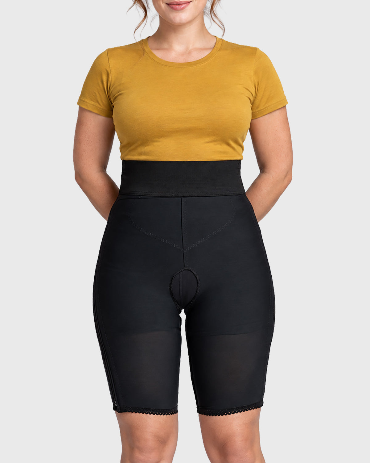 Front view of black above knee compression girdle with hook and eye closure and front zipper for post-surgical recovery