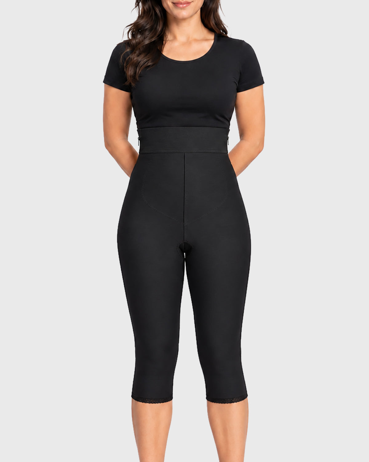 Front view of black high waist below knee compression girdle with hook and eye closure and front zipper for post-surgical recovery
