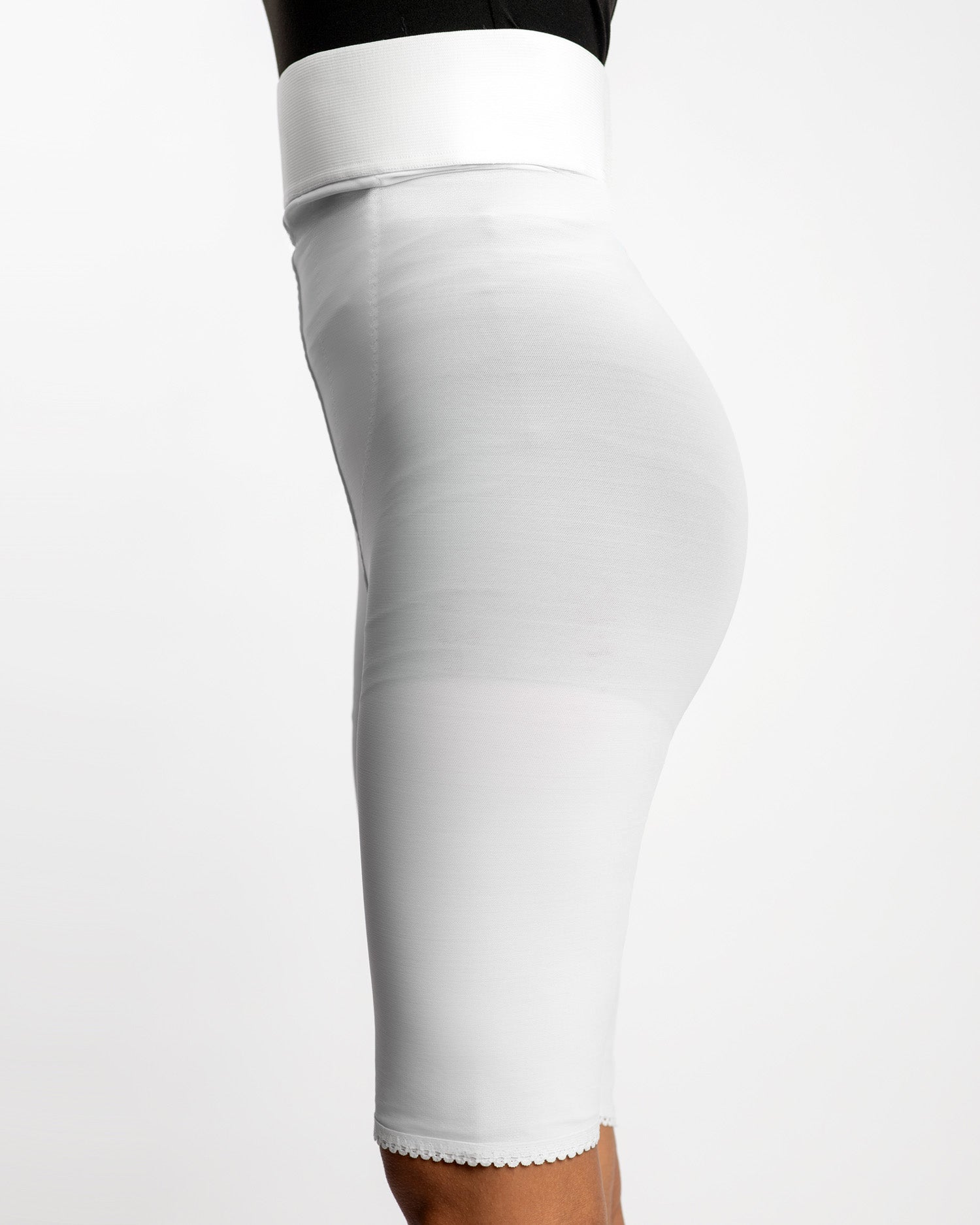 Side view of white above knee 2nd stage compression girdle for continued post-op contouring