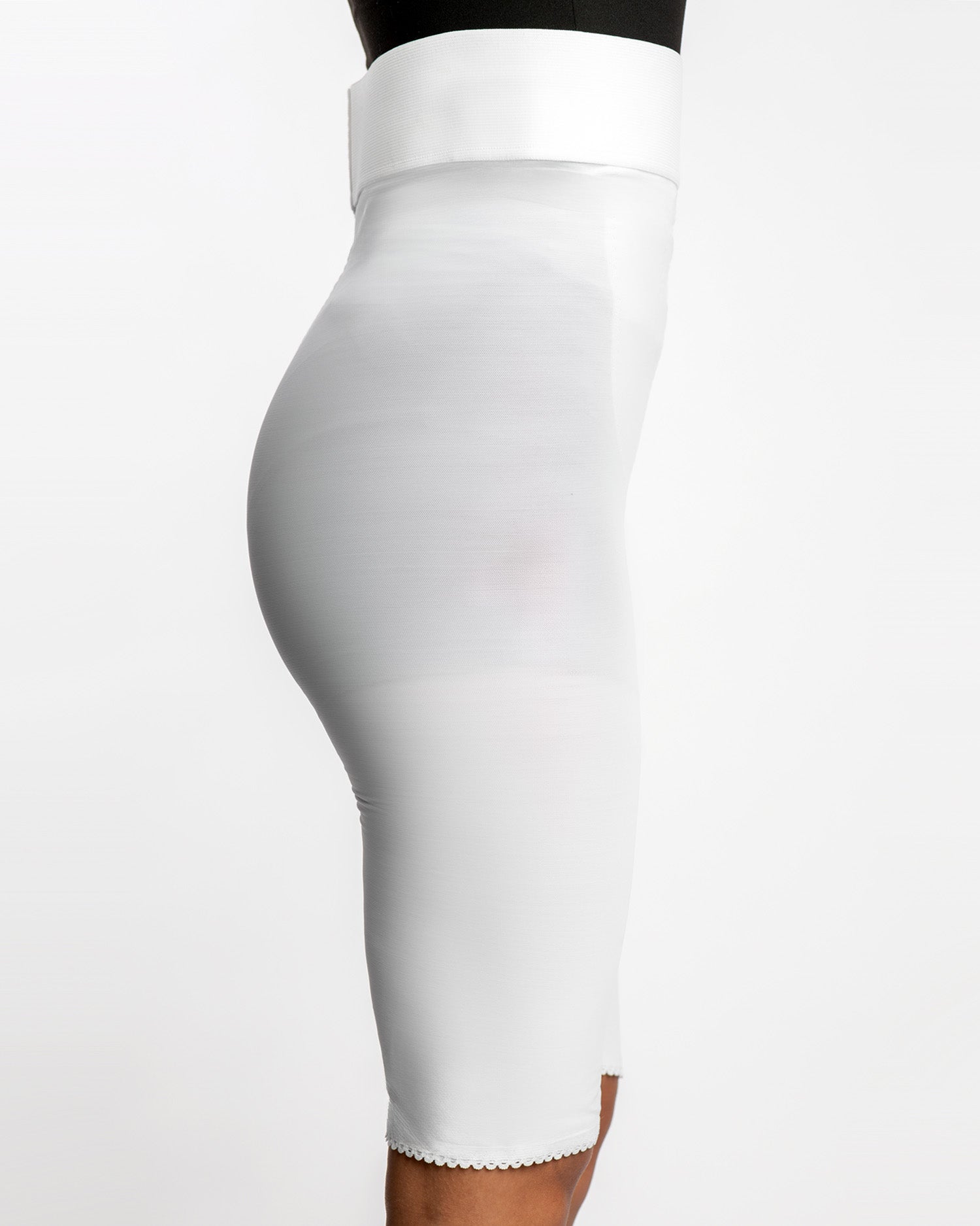 Side view of white above knee 2nd stage compression girdle for continued post-op contouring