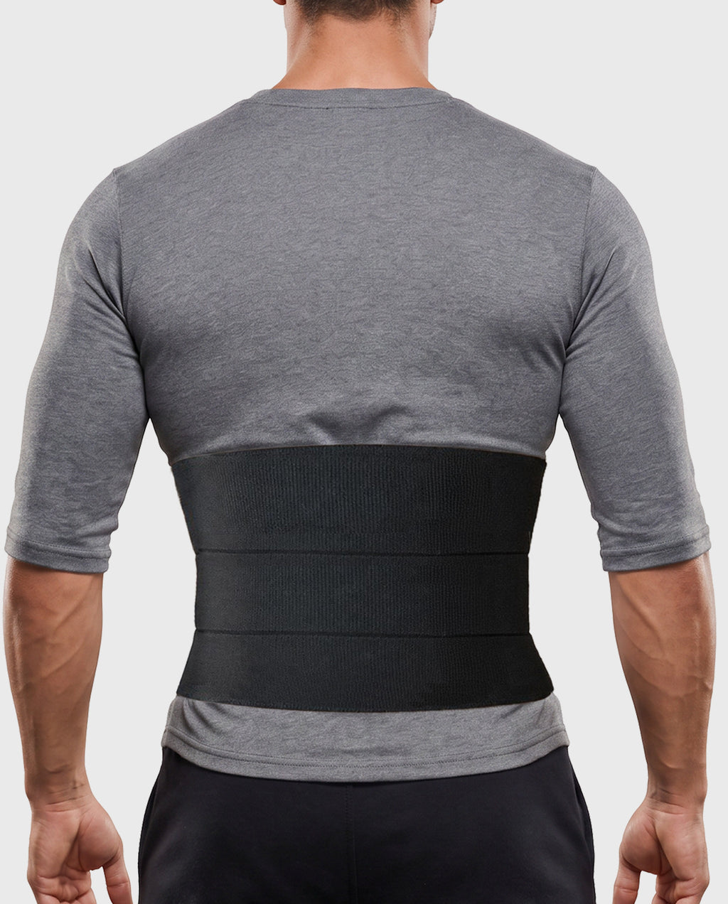 Young man wearing Frank Stubbs Universal Abdominal Binder 9" Black for abdominal support and recovery