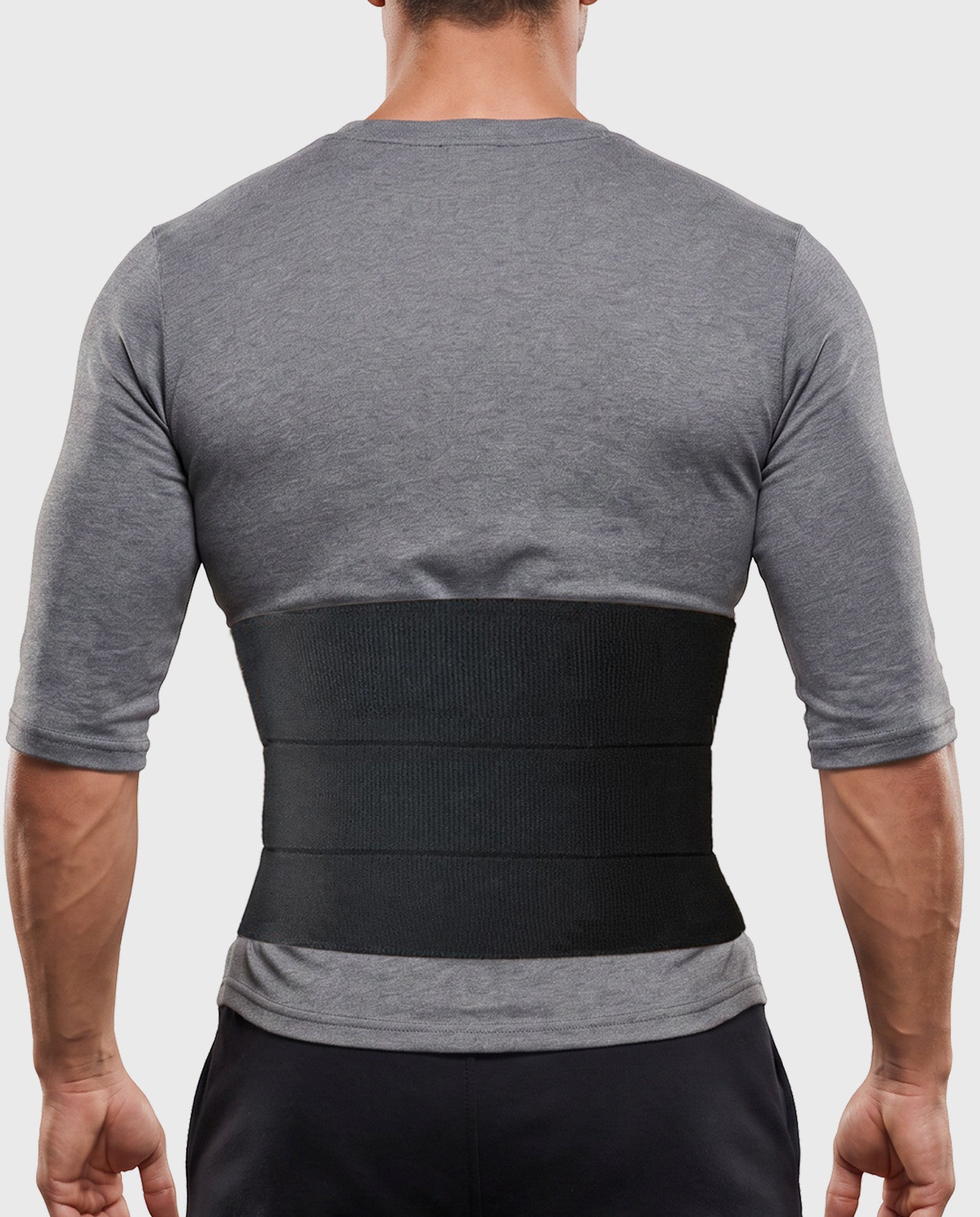 Young man wearing Frank Stubbs Universal Abdominal Binder 9" Black for abdominal support and recovery
