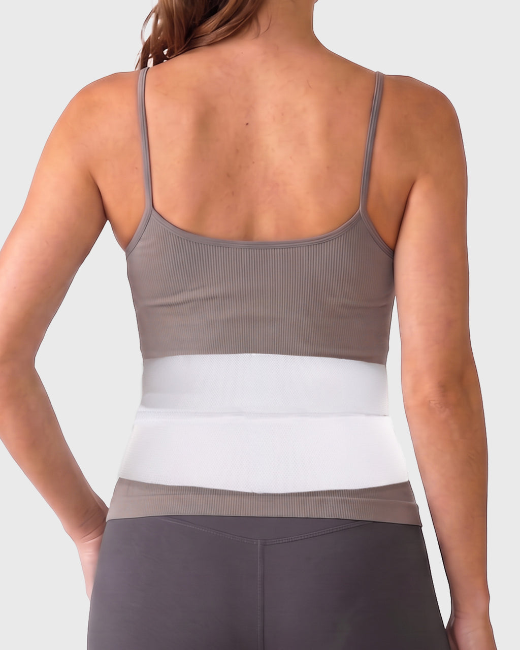 Frank Stubbs Universal 6-Inch Abdominal Binder on female model, rear view, showing low-profile abdominal support and adjustable fit