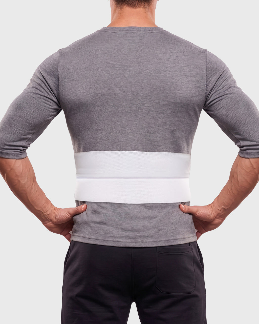 Frank Stubbs Universal 6-Inch Abdominal Binder on male model, rear view, showing low-profile abdominal support and adjustable fit