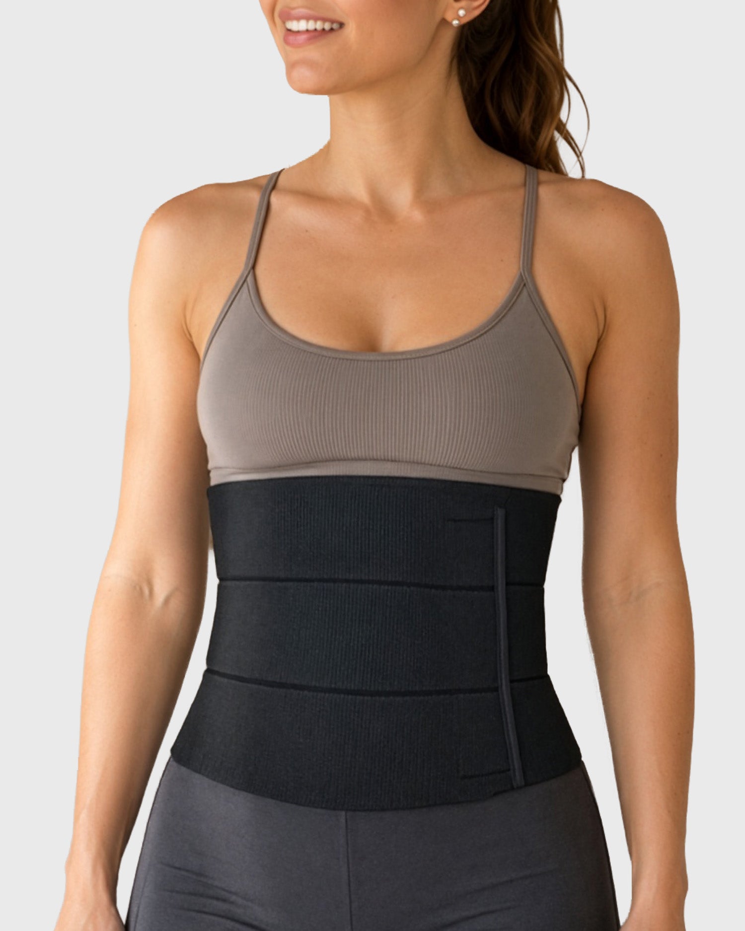 Young woman modeling the Frank Stubbs Universal Abdominal Binder 9" in Black - front view