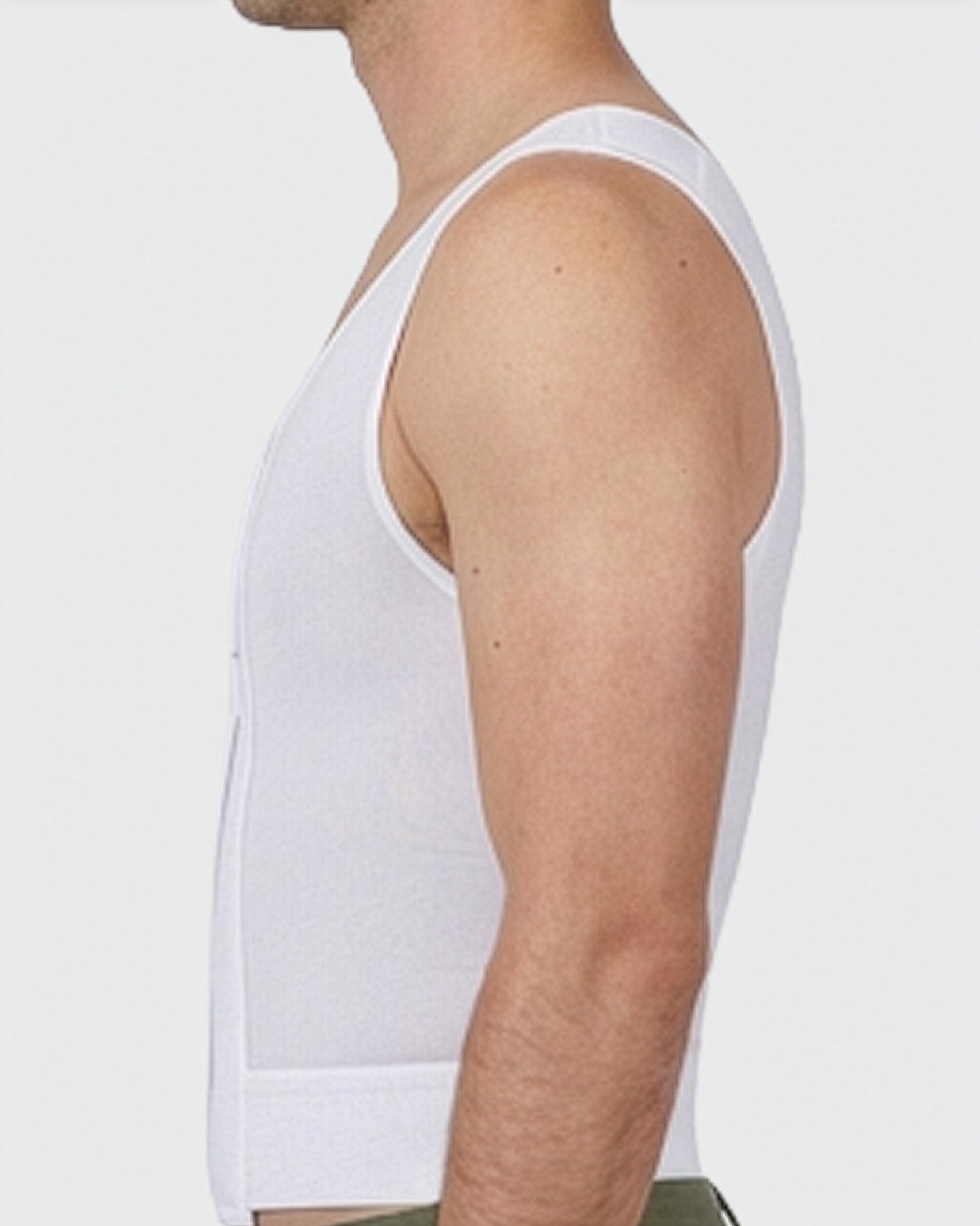 Side view of male compression vest showing contoured chest compression fit and adjustable closure