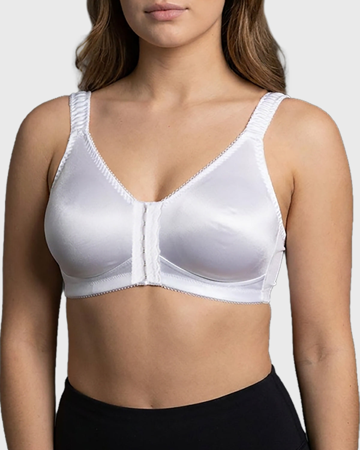 Front view of white post-surgical compression bra with front closure and adjustable straps