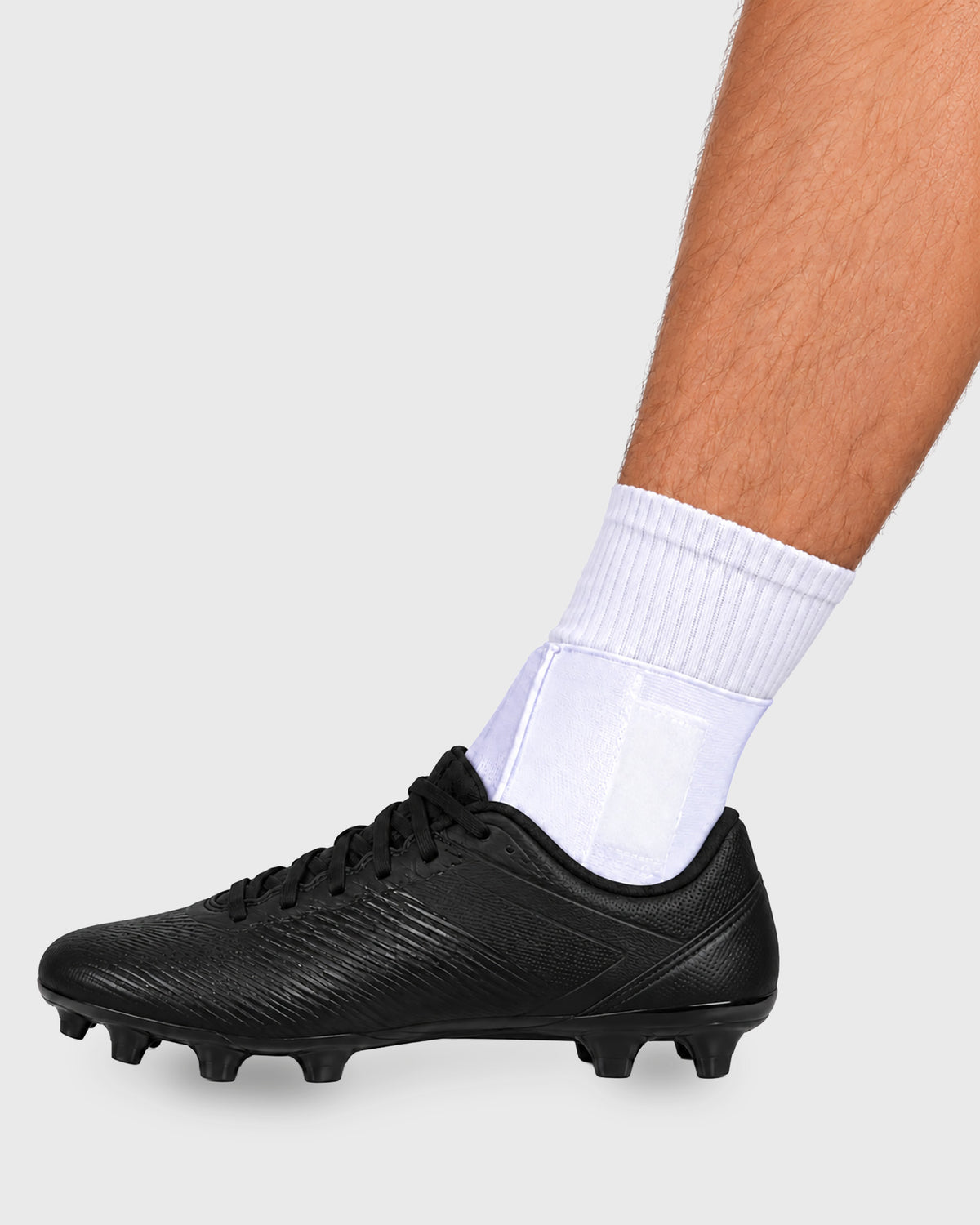 Frank Stubbs Figure 8 Ankle Wrap worn with an athletic shoe, providing adjustable ankle support.