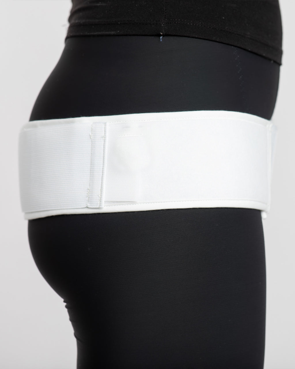 Side view of double pull trochanter belt with adjustable contact closure and compression straps for hip support and stability